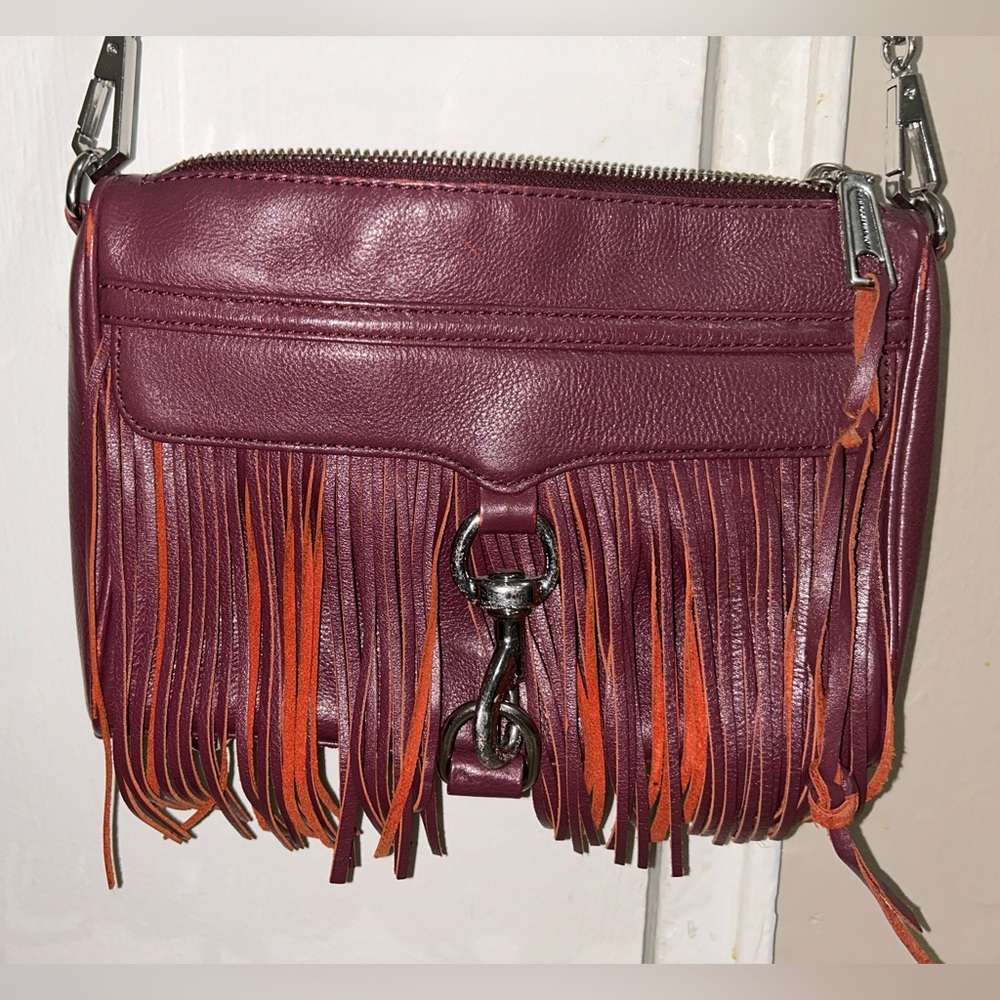 Burgundy Rebecca Minkoff shoulder bag with fringe detail and silver hardware.